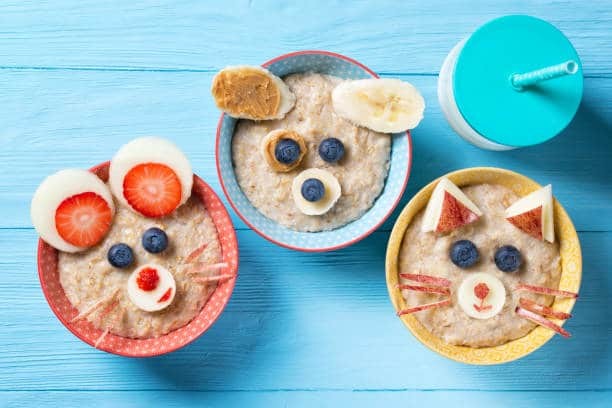 funny-bowls-with-oat-porridge-with-cat-dog-and-mouse-faces-made-of-picture-id645673782